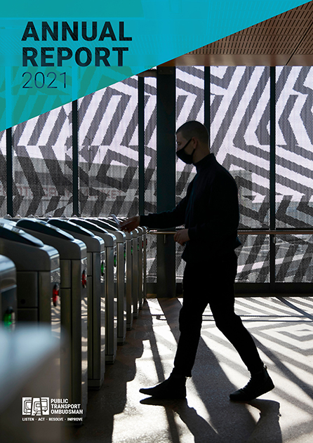 Annual Report cover shows a person walking through myki turnstiles, tapping on their myki card. The person is silhouetted by light from windows behind them, but their facemask is visible. there is a striped pattern on the window behind them.