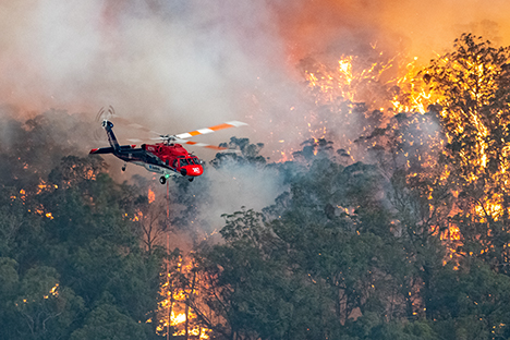 Image shows a firefighting helicopter at the Mallacoota fire. Image from DELWP via CFA Vic.