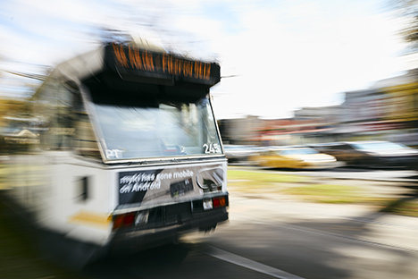 Image shows a blurred tram in motion as it passes by. 