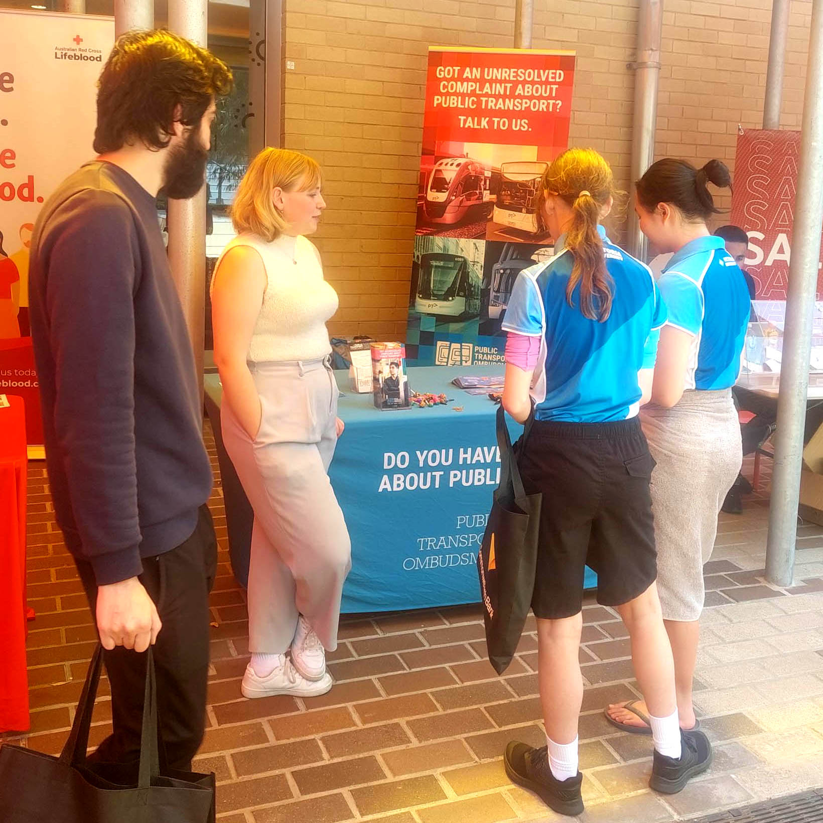 A PTO staff member talking to students at one of the Victoria University Open Days.