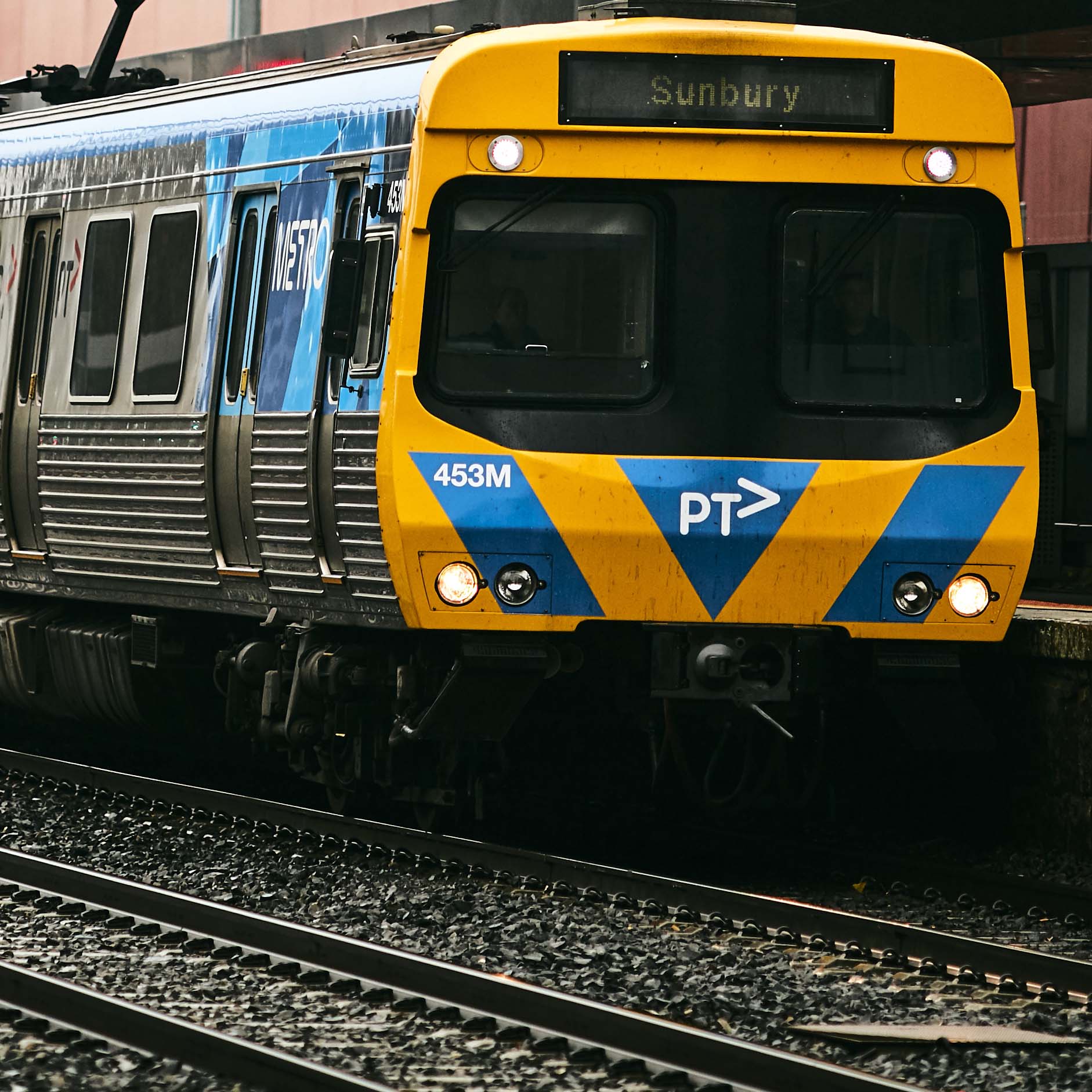 Image shows a Metro train on the Sunbury line as it pulls into a station. 