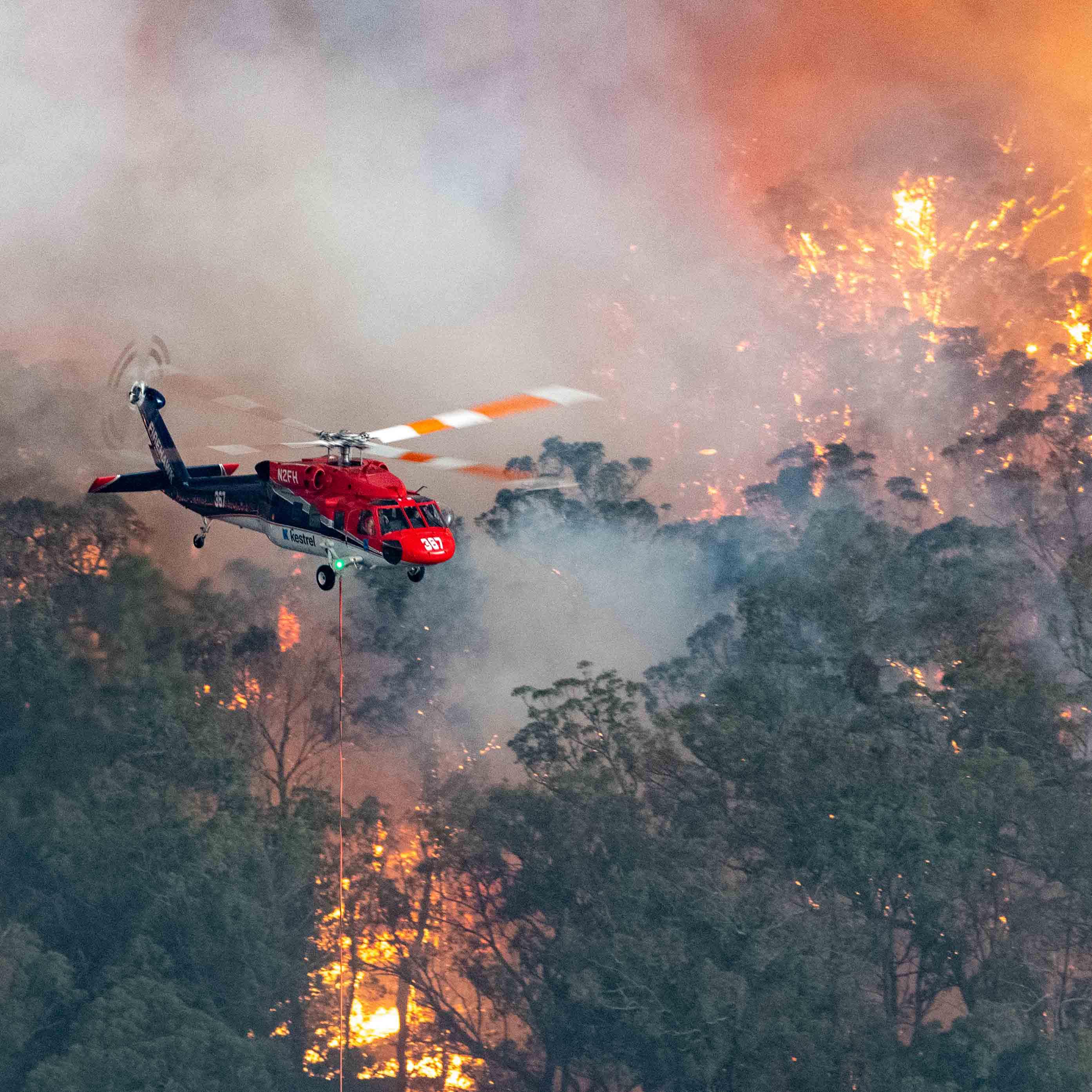 Photograph shows a firefighting helicopter at the Mallacoota fire.