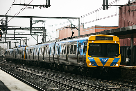 Image shows Metro Train waiting at a station platform.